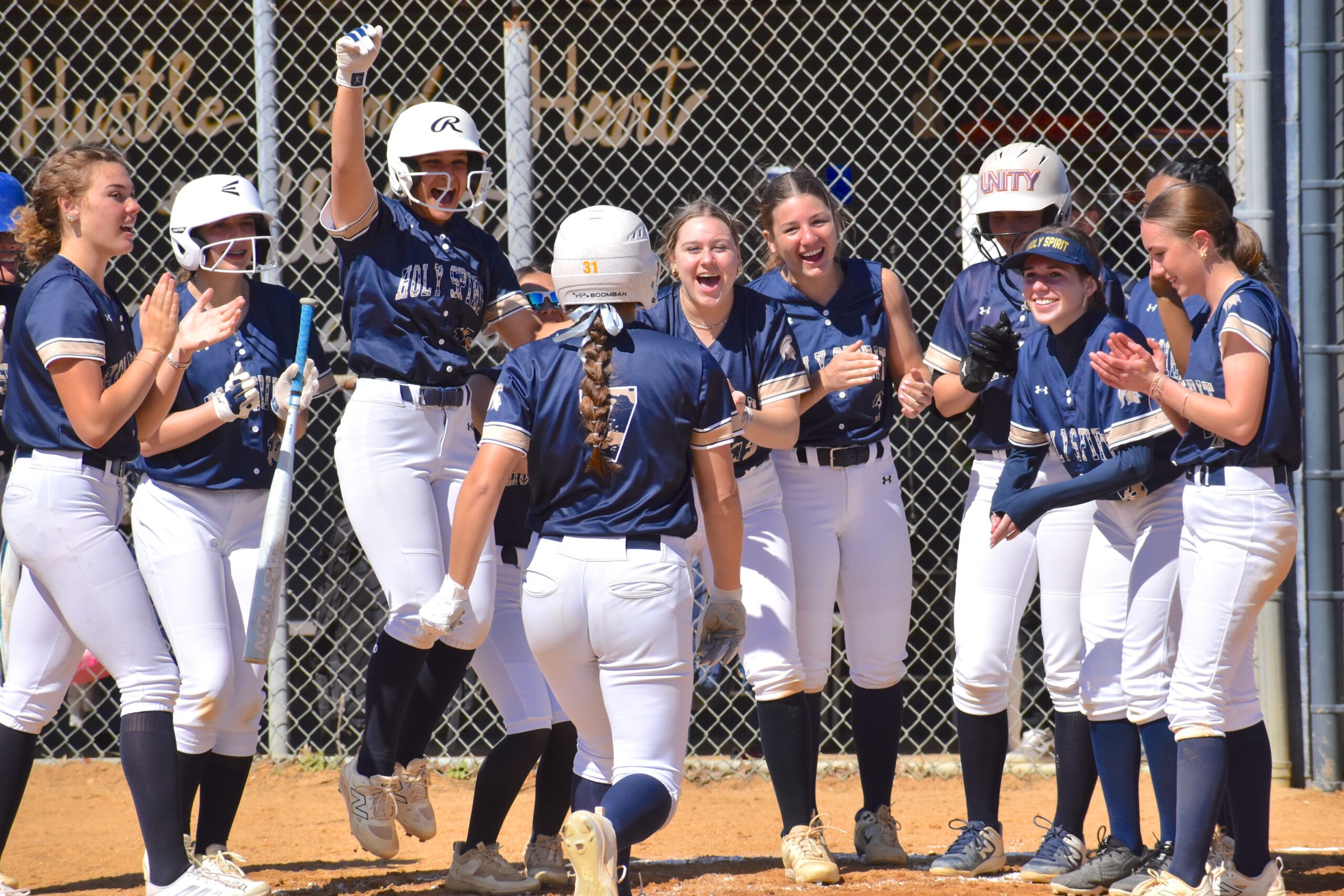 Photos by Mark Zimmaro
Holy Spirit High School senior Madi Berry (No. 7) is congratulated by teammates after hitting a grand slam in a 16-6 win over Cape May County Tech at the At Bats for Autism Acceptance Softball Invitational.