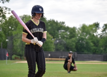 Photos by Mark Zimmaro
Rosie Richardson, Bishop Eustace Preparatory School sophomore pitcher, steps into the batter’s box as her father and coach, Doug Richardson, watches from behind third base.