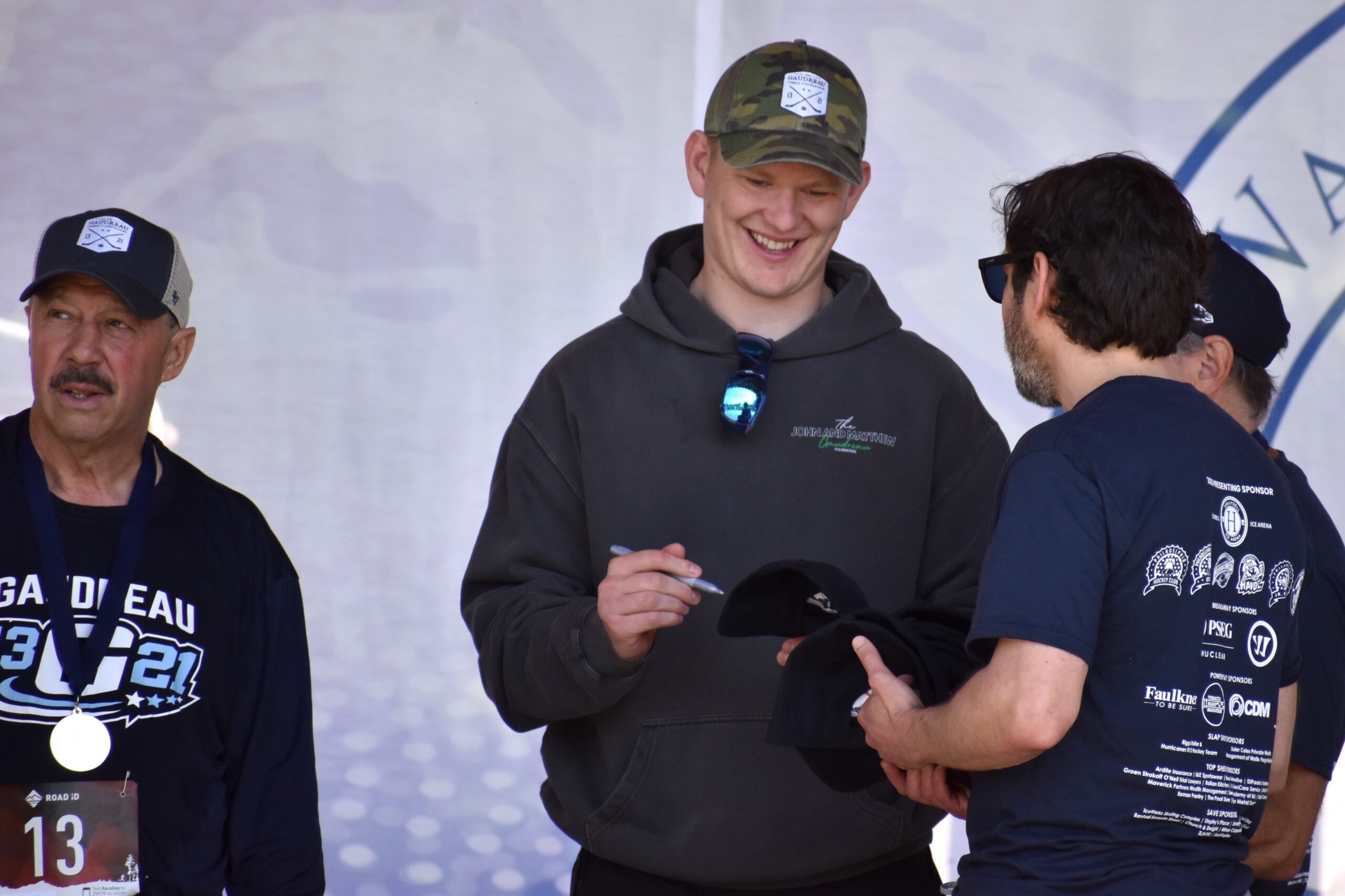 Brady Tkachuk, Ottawa Senators captain and Olympic gold medalist, signs autographs May 16 during the 2nd Annual Gaudreau 5K & Family Fun Day at Washington Lake Park. (Photos by Mark Zimmaro)