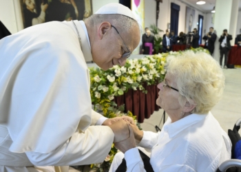 Pope Leo XIV greets a woman as he visits the Pontifical Shrine of the Blessed Virgin of the Rosary of Pompeii near Naples, Italy, before celebrating Mass in the piazza outside May 8, 2026, on the first anniversary of his election as the first American pontiff. He visited 400 sick and disabled people inside the shrine. (OSV News photo/Simone Risoluti, Vatican Media)